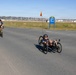 Sailors and Coast Guardsmen ride adaptive bicycles during timed trials