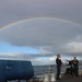 USS HOPPER Sailors standing watch with a rainbow in the background
