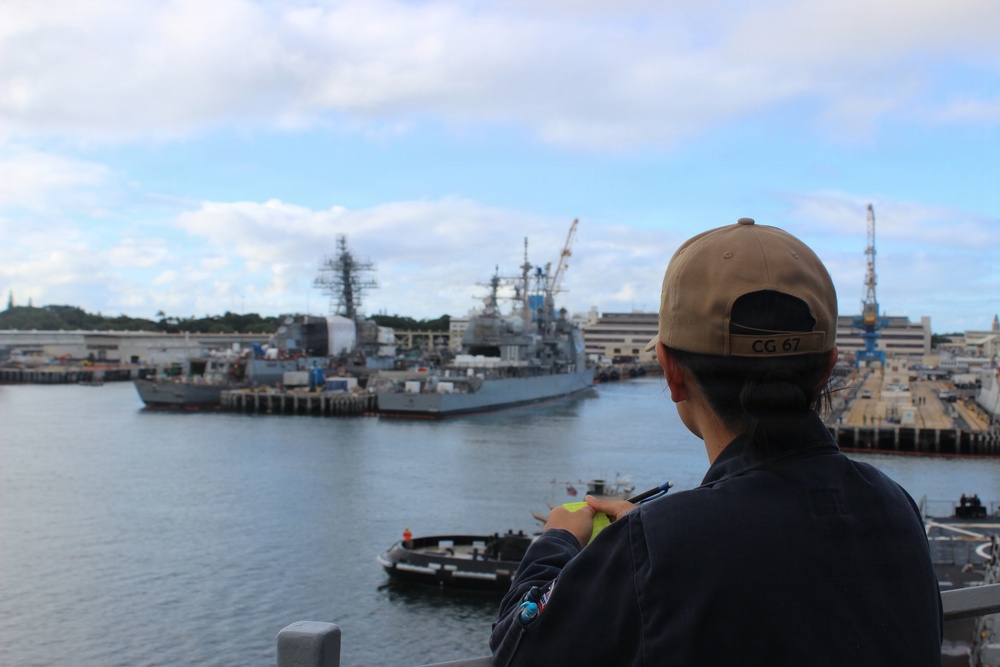USS SHILOH Sailor observes her ship following underway onboard USS HOPPER