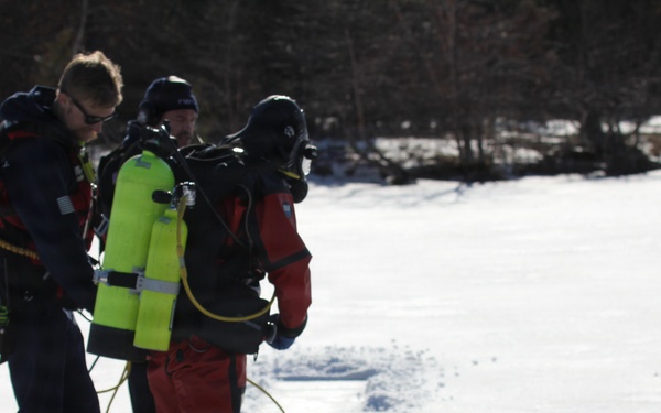 Fort McCoy firefighters practice diving under ice at post’s Big Sandy Lake during February 2026 training
