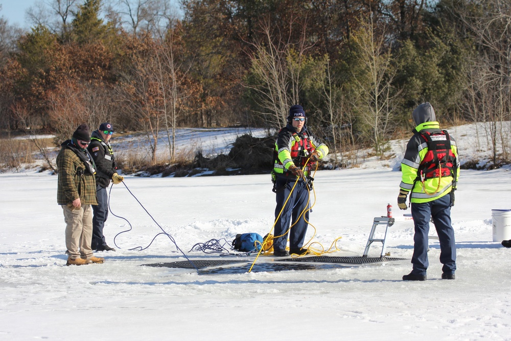 Fort McCoy firefighters practice diving under ice at post’s Big Sandy Lake during February 2026 training