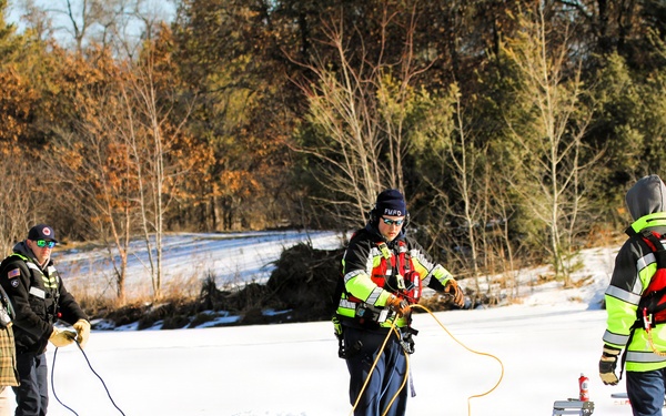 Fort McCoy firefighters practice diving under ice at post’s Big Sandy Lake during February 2026 training