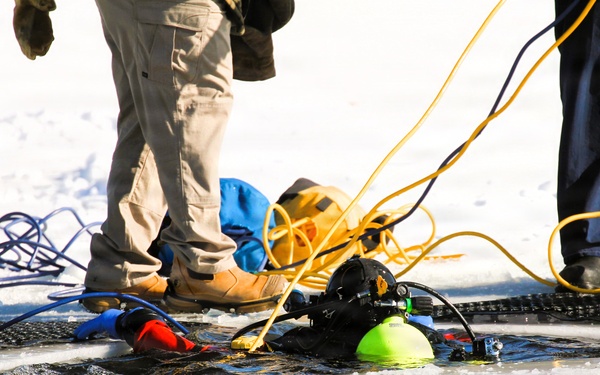 Fort McCoy firefighters practice diving under ice at post’s Big Sandy Lake during February 2026 training