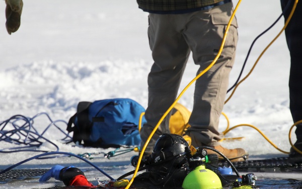 Fort McCoy firefighters practice diving under ice at post’s Big Sandy Lake during February 2026 training
