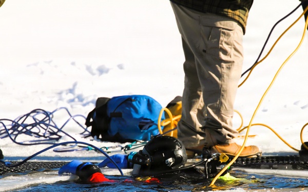 Fort McCoy firefighters practice diving under ice at post’s Big Sandy Lake during February 2026 training