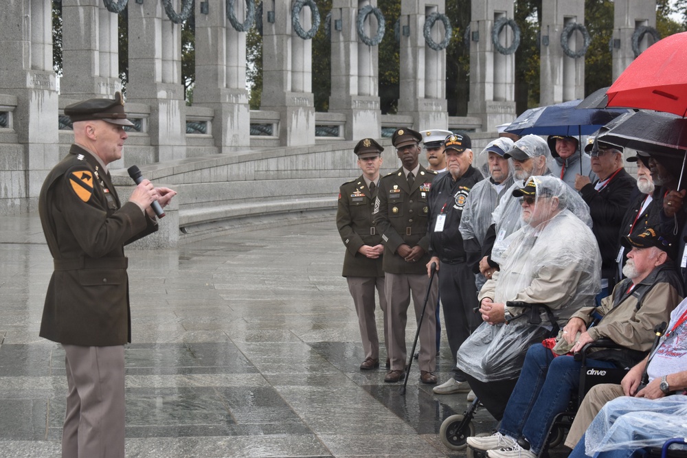 LTG John Morrison Jr., the Deputy Chief of Staff, G-6, speaks to a group of Honor Flight Service Members at the World War II Memorial