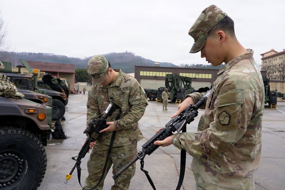 Soldiers perform weapons checks before departure