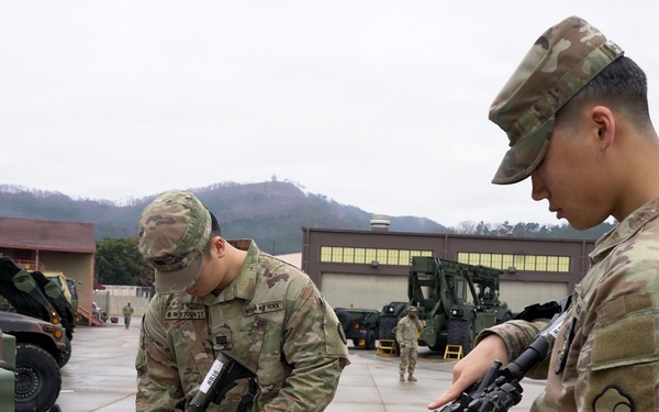 Soldiers perform weapons checks before departure