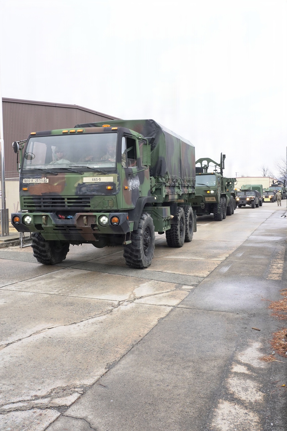 Heavy transport vehicles move out during large-scale convoy operation