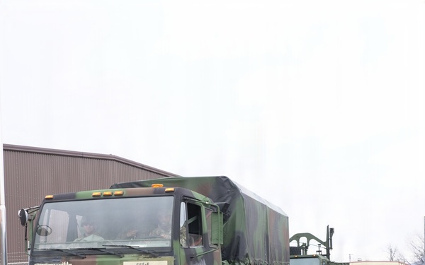 Heavy transport vehicles move out during large-scale convoy operation