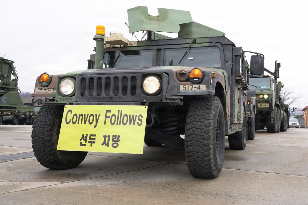 Lead convoy vehicle establishes controlled movement through civilian traffic