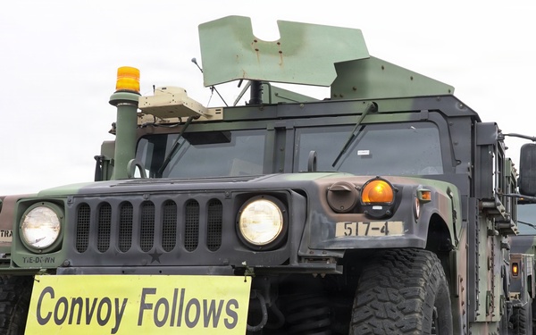 Lead convoy vehicle establishes controlled movement through civilian traffic
