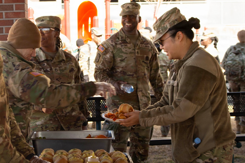 SPC KIM Receives food from fellow soldiers.