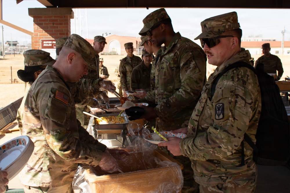 CPT Oswald serves chow to fellow soldiers.