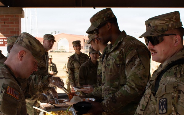 CPT Oswald serves chow to fellow soldiers.