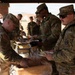 CPT Oswald serves chow to fellow soldiers.