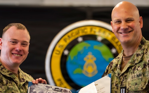LT Joel Thiesfeldt presents Musician Second Class Benjamin Morgan with the Navy and Marine Corps Achievement Medal