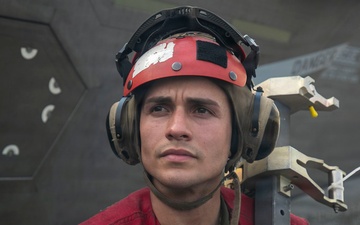 USS Tripoli Sailors Load Ordnance onto F35