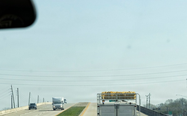 Police officers provide a motorcycle escort for the U.S. Marine Corps Mounted Color Guard to the Houston Livestock Show and Rodeo