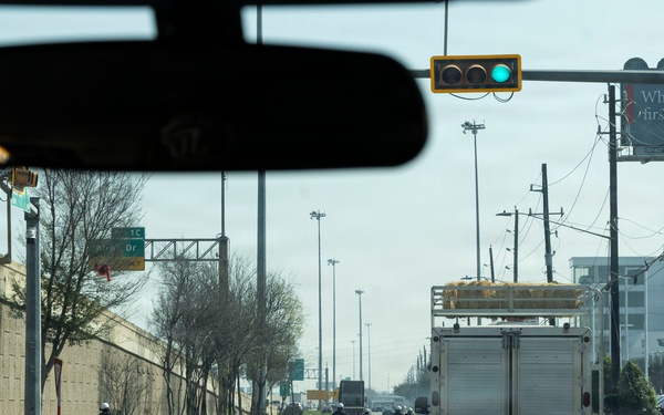 Police officers provide a motorcycle escort for the U.S. Marine Corps Mounted Color Guard to the Houston Livestock Show and Rodeo