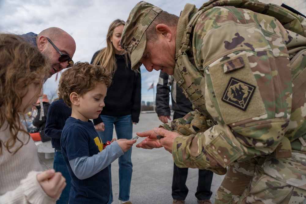 Mississippi National Guard Adjutant General gives a coin to a member of the public