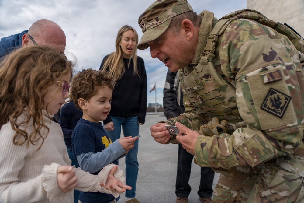 Mississippi National Guard Adjutant General gives a coin to a member of the public