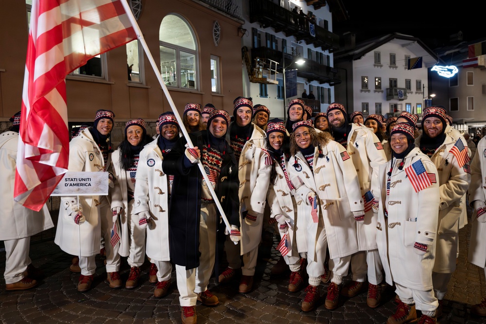 Sgt. Frank Del Duca carries the flag for the Opening Ceremonies for the 2026 Winter Olympics