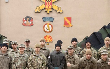 Sergeant Shin and KATUSA Soldiers pose for a group photo after his ETS cereomony.