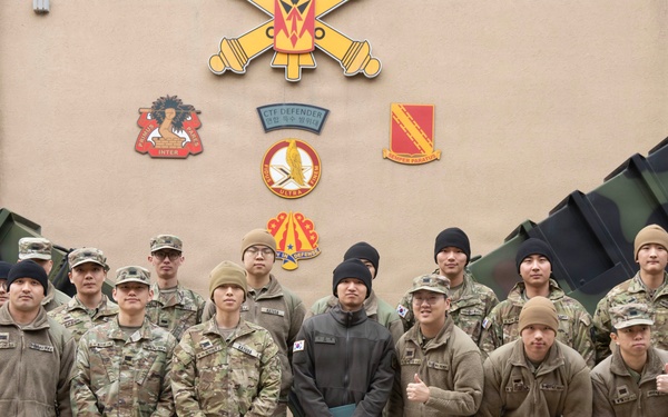 Sergeant Shin and KATUSA Soldiers pose for a group photo after his ETS cereomony.