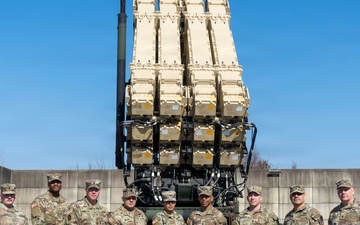 Leadership from Delta Battery, 6-52 Battalion, 35th Air Defense Artillery Brigade and Command Sergeant Weaver Pose in Front of Launchers