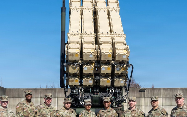 Leadership from Delta Battery, 6-52 Battalion, 35th Air Defense Artillery Brigade and Command Sergeant Weaver Pose in Front of Launchers