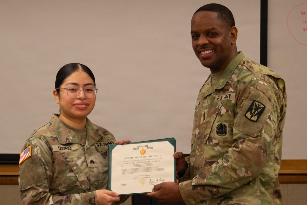 Sergeant Osorio is presented the Army Commendation Medal from the 35th Air Defense Artillery Brigade