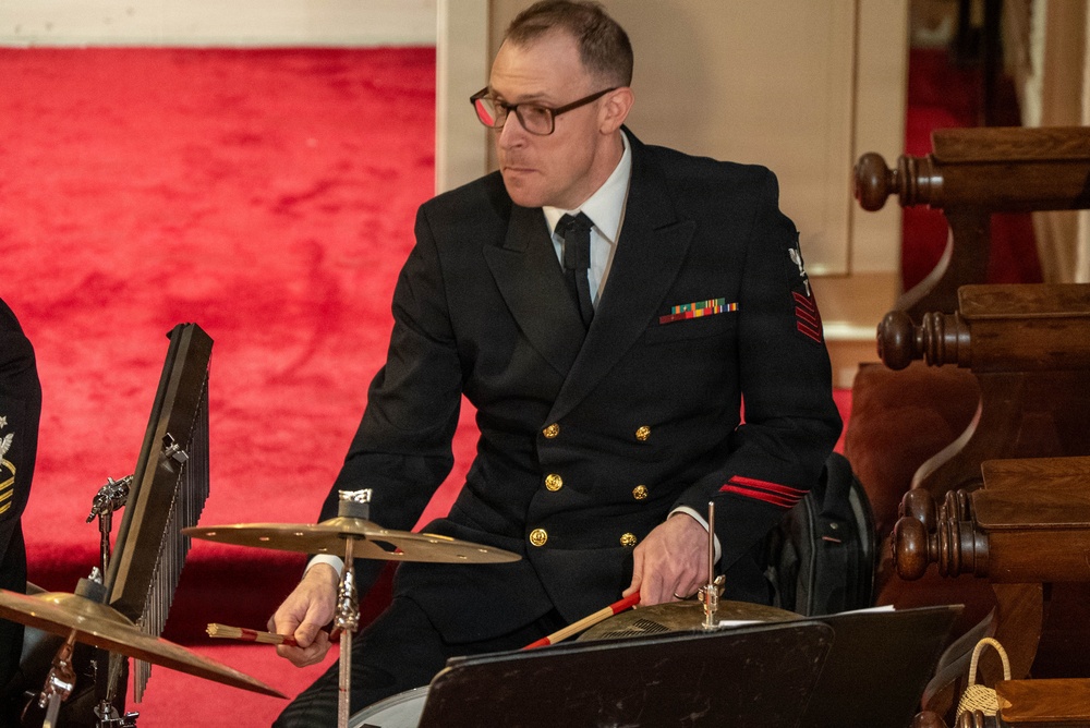 Musician 1st Class David Agee of the US Navy Band Sea Chanters performs at St. John's Episcopal Church in New Hampshire during their 2026 National Tour