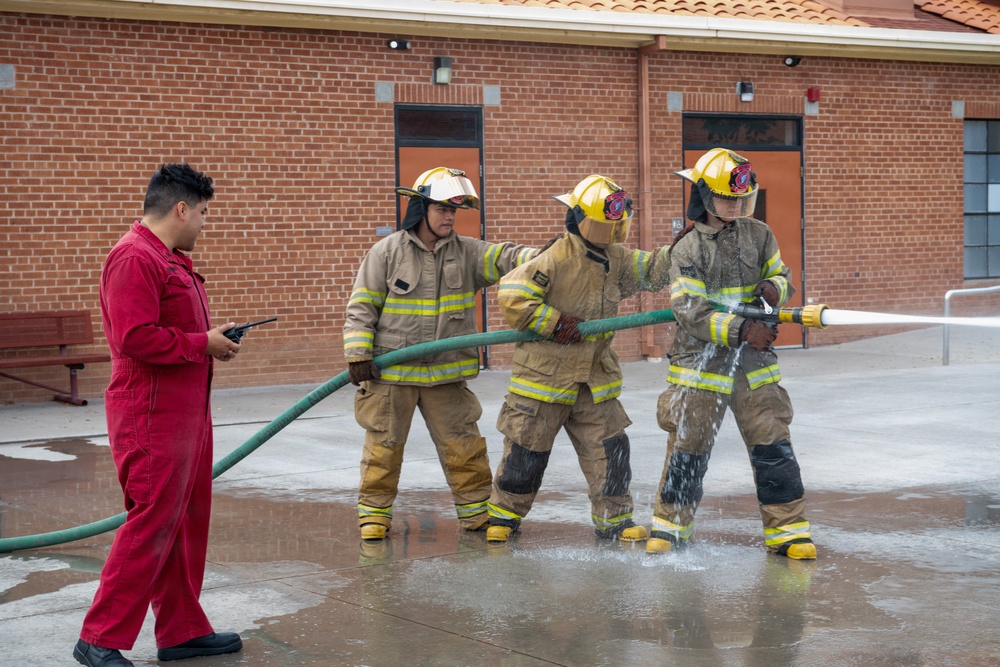 Navy Recruiter Returns to Alma Mater to Lead Damage Control Drill
