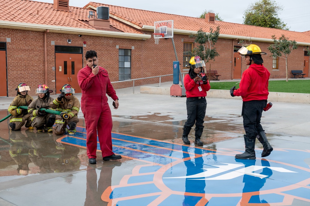 Navy Recruiter Returns to Alma Mater to Lead Damage Control Drill