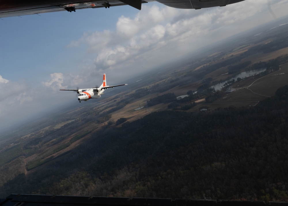 A U.S. Coast Guard HC-144 Ocean Sentry flies over Auburn, Alabama