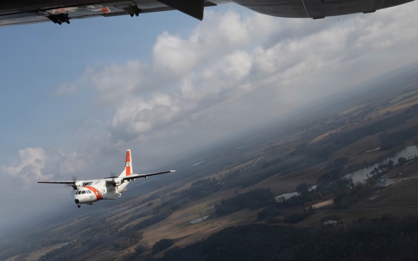 A U.S. Coast Guard HC-144 Ocean Sentry flies over Auburn, Alabama