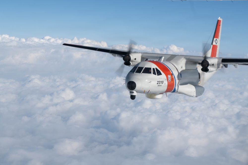 A U.S. Coast Guard HC-144 Ocean Sentry flies above the clouds