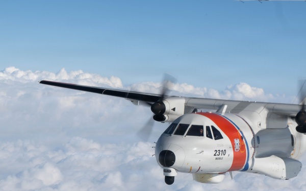 A U.S. Coast Guard HC-144 Ocean Sentry flies above the clouds