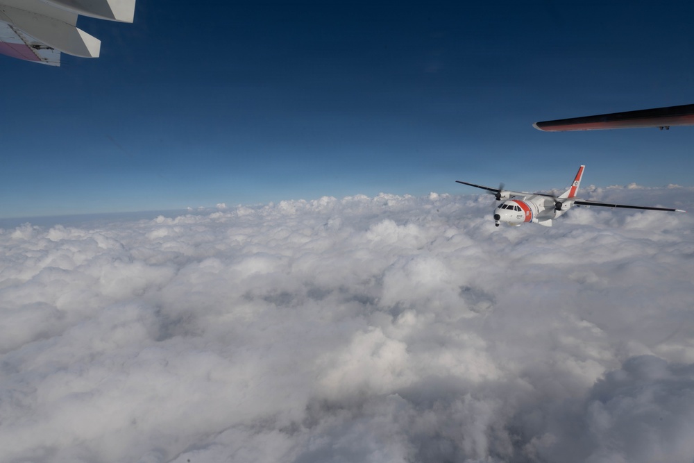 A U.S. Coast Guard HC-144 Ocean Sentry flies above the clouds