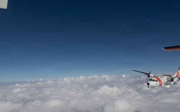 A U.S. Coast Guard HC-144 Ocean Sentry flies above the clouds