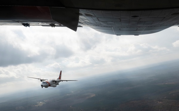 A U.S. Coast Guard HC-144 Ocean Sentry flies over Auburn, Alabama