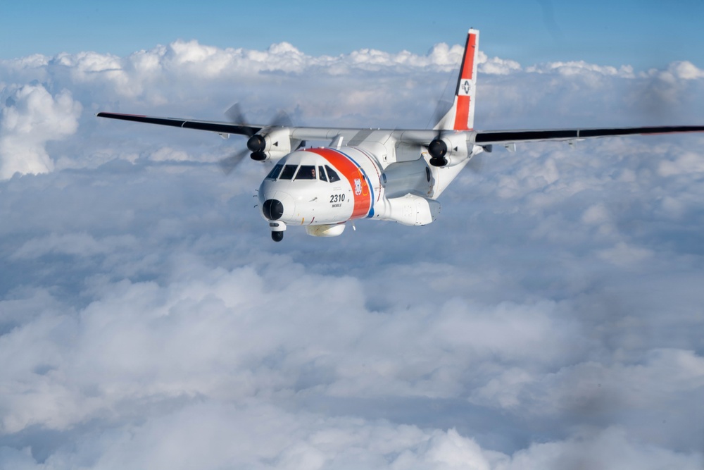 A U.S. Coast Guard HC-144 Ocean Sentry flies above the clouds