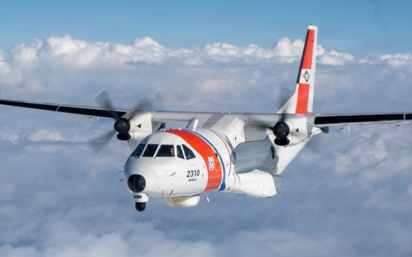 A U.S. Coast Guard HC-144 Ocean Sentry flies above the clouds
