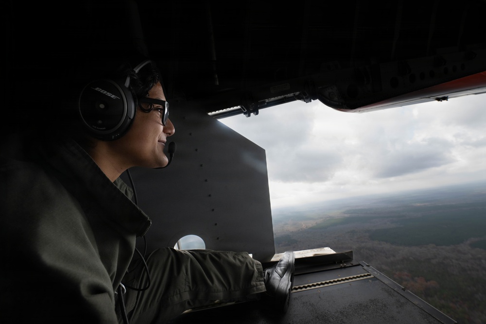 Aviation Electrical Technician looks off the rear ramp of a HC-144 Ocean Sentry