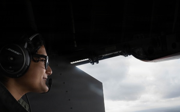 Aviation Electrical Technician looks off the rear ramp of a HC-144 Ocean Sentry