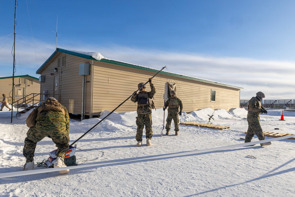 US Marines construct a field expedient antenna during ARCTIC EDGE 2026