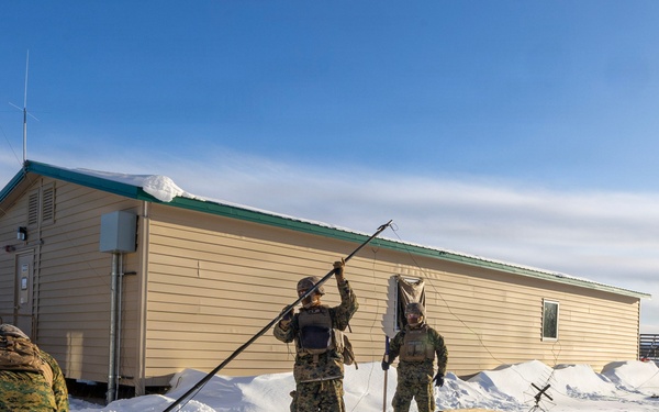 US Marines construct a field expedient antenna during ARCTIC EDGE 2026