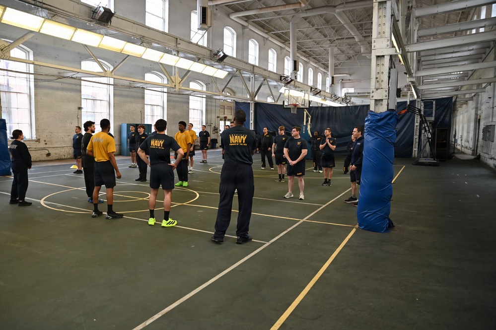 NSAW personnel stand in formation for physical training