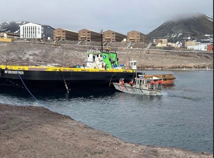USCGC Polar Star (WAGB 10) supports the installation of a pier in McMurdo Station during Operation Deep Freeze 2026